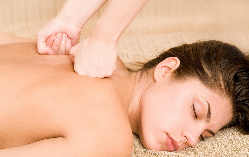 Woman lying face down receiving sports massage